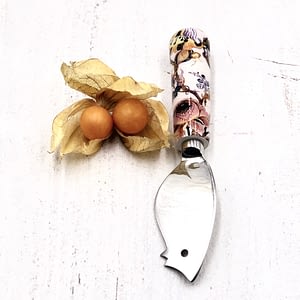 White, with pink & yellow flowers, mouse cheese knife